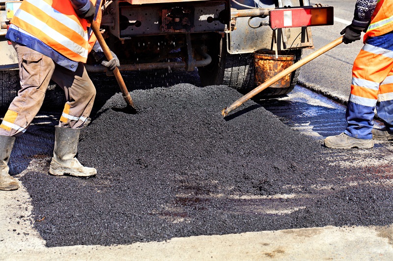 workers installing asphalt